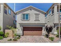 Two-story house with brown garage door and landscaped yard at 8035 Skye Foxx St, Las Vegas, NV 89166