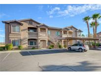 Tan two-story building with parking and palm trees at 8805 Jeffreys St # 1032, Las Vegas, NV 89123