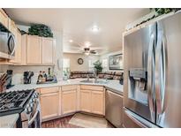 Modern kitchen with stainless steel appliances and light wood cabinets at 9103 Mcginnis Ave, Las Vegas, NV 89148