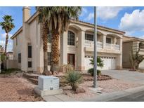 Two-story house with a large driveway and palm trees at 9852 Snowy Canyon Ct, Las Vegas, NV 89183