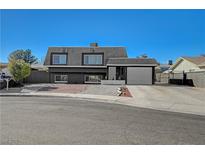 Two-story house with gray exterior, landscaped yard, and driveway at 108 Breeze Ct, Las Vegas, NV 89145