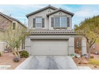 Two-story house with attached garage and landscaping at 10810 Hunters Green Ave, Las Vegas, NV 89166