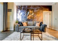 Stylish living room features a gray sofa, coffee table, and Elvis-themed wall art at 125 E Harmon Ave # 3214, Las Vegas, NV 89109