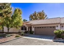 Attractive stucco home with a two-car garage and landscaped yard at 1911 Hobson Dr, Henderson, NV 89074