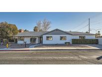 Ranch style home with a gray roof, white exterior, and well-manicured landscaping at 200 Rancho Vista Dr, Las Vegas, NV 89106