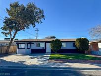 Ranch style home with a well-manicured lawn and driveway at 2820 Richfield Blvd, Las Vegas, NV 89102