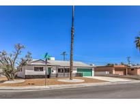 Charming single story home with a green door and well-manicured landscaping at 3314 El Camino Real, Las Vegas, NV 89121