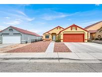 House exterior with orange garage door and rock landscaping at 3434 Empress Diamond Dr, North Las Vegas, NV 89032