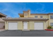 Tan two-story building with attached garages and a well-maintained exterior at 3604 Lisandro St # 201, Las Vegas, NV 89108