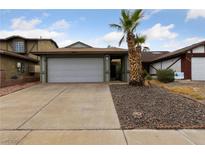 Single story house with attached garage and desert landscaping at 504 Crony Ave, Henderson, NV 89011