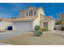 Two-story home features a tile roof, attached two car garage, and desert landscaping at 7214 Paradise Bay Dr, Las Vegas, NV 89119