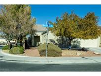 House exterior featuring a landscaped yard and two-car garage at 904 Kevin Baker Ave, North Las Vegas, NV 89086