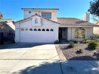 Charming two-story home with a two-car garage, landscaped front yard, and a well-maintained exterior at 1429 Hawkwood Rd, Henderson, NV 89014