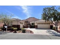Charming single-story home with a desert landscape, two-car garage, and tile roof at 1963 Dakota Lodge Ave, Las Vegas, NV 89123