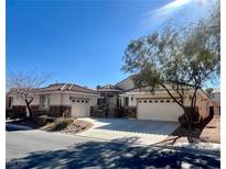 Single-story home with two-car garage and landscaped front yard at 1963 Dakota Lodge Ave, Las Vegas, NV 89123