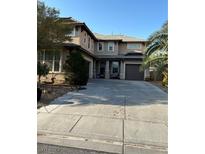 Two-story house with attached garage and landscaping at 2621 Slide Canyon Ave, North Las Vegas, NV 89081