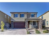Two-story house with stone accents and a two-car garage at 319 Cooper Hawk Ct, Las Vegas, NV 89138