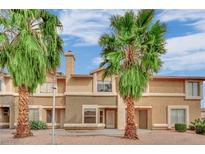 Inviting multi-Gathering home featuring stucco siding and desert landscaping, complemented by mature palm trees and a blue sky at 3891 Terrazzo Ave, Las Vegas, NV 89115