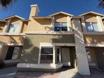 Inviting townhome featuring a unique exterior with beige and olive tones and well-maintained landscaping at 3891 Terrazzo Ave, Las Vegas, NV 89115