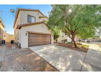 Two-story house with brown garage door and landscaped front yard at 4174 Jacqueline Way, Las Vegas, NV 89115