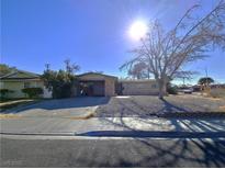Ranch style home with carport and mature tree in front yard at 4413 Buckeye Ave, Las Vegas, NV 89102