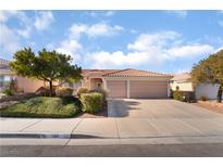 Single-story house with a three-car garage and well-manicured landscaping at 585 Duran St, Henderson, NV 89015
