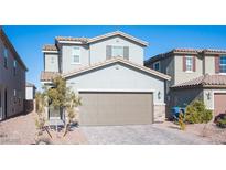Two-story house with attached garage and landscaped front yard at 6586 Rustic Saddle Ct, Las Vegas, NV 89141