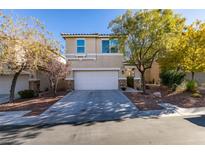 Two-story house with attached garage and landscaped front yard at 7640 Houston Peak St, Las Vegas, NV 89166