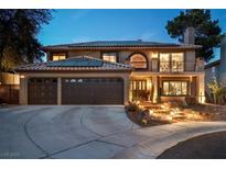 Charming two-story home boasts a tile roof, balcony, and well-maintained landscaping at 8940 Sailplane Ave, Las Vegas, NV 89129