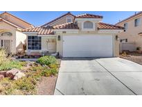 Charming single-story home showcasing a well-maintained front yard and attached two-car garage at 928 Carmel Shores Dr, Las Vegas, NV 89128