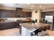 Modern kitchen with granite countertops and stainless steel appliances at 10766 Wild Parsley Ave, Las Vegas, NV 89129