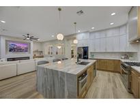 Gourmet kitchen boasts expansive island, modern cabinetry, and high-end appliances at 1343 Panini Dr, Henderson, NV 89052