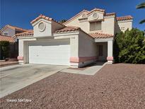 Two-story house with attached garage and landscaped yard at 1732 Monte Alban Dr, North Las Vegas, NV 89031