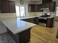 Modern kitchen featuring stainless steel appliances and quartz countertops at 1732 Monte Alban Dr, North Las Vegas, NV 89031