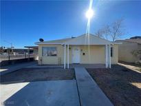 Cute yellow house with a covered porch and small front yard at 2410 Poplar Ave, Las Vegas, NV 89101