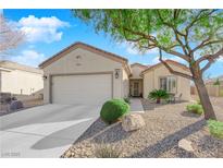 Single-story house with a two-car garage and landscaped front yard at 2525 Shore Bird Ave, North Las Vegas, NV 89084