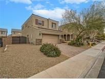 Two-story house with a landscaped yard, driveway, and attached garage at 372 Monique Springs St, Henderson, NV 89014