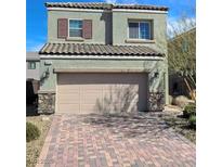 Two-story house with neutral exterior, attached garage, and brick driveway at 372 Monique Springs St, Henderson, NV 89014