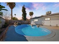 Inviting kidney-shaped pool with waterfall feature in backyard at 3939 Springhill Ave, Las Vegas, NV 89121