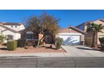 Single-story home with a two-car garage and landscaped front yard at 4030 Allyson Rae St, North Las Vegas, NV 89032