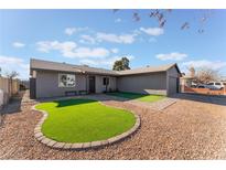 Ranch style home with artificial turf and a paved walkway at 4825 Greencreek Dr, Las Vegas, NV 89110