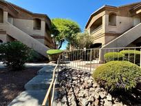 Neatly landscaped complex with two-story buildings and walkways at 5751 E Hacienda Ave # 114, Las Vegas, NV 89122