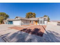 Single-story house with a two-car garage and landscaped front yard at 6200 Budnick Cir, Las Vegas, NV 89130