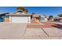 One-story house with a two-car garage and landscaped front yard at 6200 Budnick Cir, Las Vegas, NV 89130