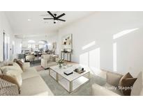 Bright living room features stylish furniture and flows into the dining area at 6304 Tanzanite Ave, Las Vegas, NV 89130