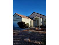 Single-story house with a terracotta tile roof and landscaped front yard at 637 Bay Bridge Dr, North Las Vegas, NV 89032