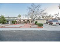 Ranch style home with mature landscaping, large driveway and two-car garage at 6513 Hyde Ave, Las Vegas, NV 89107