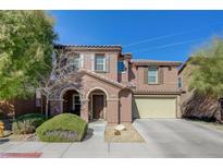 Two story house with beige exterior, attached garage, and landscaping at 7182 Hood River Ave, Las Vegas, NV 89179