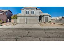 Two-story house with three-car garage and landscaped front yard at 7900 Holly Knoll Ave, Las Vegas, NV 89129