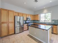 Bright kitchen with stainless steel appliances and an island at 12 Fallows Fire Ct, Henderson, NV 89052